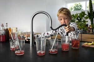 child fills cups with water